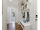 Welcoming foyer with built-in storage bench, shiplap accent wall, and hardwood floors at 242 Sweet Pine Cir, Pittsboro, NC 27312