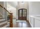 Grand foyer featuring high ceilings, wood floors, and large double doors at 242 Sweet Pine Cir, Pittsboro, NC 27312