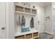 Beautiful foyer with a white bench, coat hooks, storage and wood flooring at 242 Sweet Pine Cir, Pittsboro, NC 27312