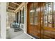 Inviting front porch with rocking chairs, a stained front door, and beautiful wood detailing at 242 Sweet Pine Cir, Pittsboro, NC 27312