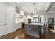 Open kitchen with a center island, stainless steel appliances, and custom cabinetry at 242 Sweet Pine Cir, Pittsboro, NC 27312