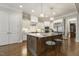 Bright, open kitchen with stainless steel appliances, island with seating, and hardwood floors at 242 Sweet Pine Cir, Pittsboro, NC 27312