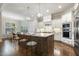 Spacious kitchen with a large island, modern lighting, and stainless steel appliances at 242 Sweet Pine Cir, Pittsboro, NC 27312
