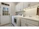 The laundry room includes a utility sink, washer, dryer, and a door to the outside at 242 Sweet Pine Cir, Pittsboro, NC 27312