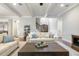 Open living space with hardwood floors, seating area, and staircase at 242 Sweet Pine Cir, Pittsboro, NC 27312