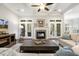 Open living space featuring a fireplace and french doors to the exterior at 242 Sweet Pine Cir, Pittsboro, NC 27312
