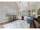 Bright living area boasting built-in shelving, wine cooler, wet bar, and hardwood flooring at 242 Sweet Pine Cir, Pittsboro, NC 27312