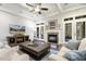 Cozy living room with a fireplace, coffered ceilings, and french doors to the patio at 242 Sweet Pine Cir, Pittsboro, NC 27312