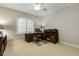 Office featuring wooden desk, chair, ceiling fan and window with shutters at 242 Sweet Pine Cir, Pittsboro, NC 27312