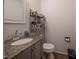 Compact half-bath with granite-topped vanity and sleek fixtures, ideal for guests at 2518 Pilot Riley Rd, Zebulon, NC 27597