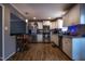 Bright kitchen with stainless steel appliances, white cabinets, and wood-look flooring at 2518 Pilot Riley Rd, Zebulon, NC 27597