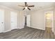 Cozy bedroom features neutral walls, ceiling fan, hardwood-style floors, and ensuite bathroom at 2606 Landis Dr, Durham, NC 27705