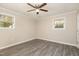 Bright bedroom with hardwood-style floors, neutral walls, ceiling fan, and windows providing plenty of natural light at 2606 Landis Dr, Durham, NC 27705