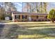 Charming ranch-style home with brick facade, manicured front yard, and a detached storage shed at 2606 Landis Dr, Durham, NC 27705