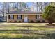 Inviting ranch-style home with brick exterior, lush landscaping and a manicured lawn at 2606 Landis Dr, Durham, NC 27705