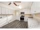 Modern kitchen features stainless steel appliances, white cabinetry, stylish countertops, and hardwood-style flooring at 2606 Landis Dr, Durham, NC 27705