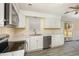 Modern kitchen features white cabinets, stainless steel appliances, stylish countertop, and hardwood-style flooring at 2606 Landis Dr, Durham, NC 27705