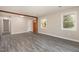 Bright living room with two large windows, hardwood flooring, and a wooden beam providing structural support at 2606 Landis Dr, Durham, NC 27705