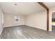 Spacious living room with neutral paint, hardwood floors and a large window letting in plenty of natural light at 2606 Landis Dr, Durham, NC 27705
