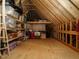 Unfinished attic space featuring exposed beams, plywood flooring and ample storage at 2609 Packhouse Rd, Zebulon, NC 27597