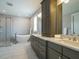 A well-lit bathroom showcasing a soaking tub, glass-enclosed shower, and double sink vanity at 2609 Packhouse Rd, Zebulon, NC 27597