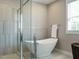 A luxurious bathroom with a standalone tub and glass shower at 2609 Packhouse Rd, Zebulon, NC 27597