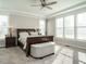 Bright bedroom with a large window, ceiling fan, and a dark wood sleigh bed at 2609 Packhouse Rd, Zebulon, NC 27597