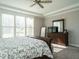 Bedroom with tray ceiling, a dresser, and large windows offering plenty of natural light at 2609 Packhouse Rd, Zebulon, NC 27597