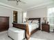 Main bedroom featuring a sleigh bed, ceiling fan, carpet and bedside tables at 2609 Packhouse Rd, Zebulon, NC 27597