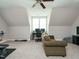 Finished bonus room features carpet, natural light, and a cozy couch for relaxing at 2609 Packhouse Rd, Zebulon, NC 27597