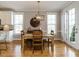 Light-filled dining room featuring hardwood floors, modern chandelier, and access to the backyard at 2609 Packhouse Rd, Zebulon, NC 27597