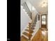 Elegant entryway featuring hardwood floors, a staircase with wrought iron railings, and a stained-glass front door at 2609 Packhouse Rd, Zebulon, NC 27597