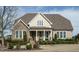 Inviting home with stone accents, covered porch and professional landscaping at 2609 Packhouse Rd, Zebulon, NC 27597