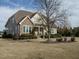 A beautiful single Gathering home with stone accents, a covered porch, and mature trees in a well-kept yard at 2609 Packhouse Rd, Zebulon, NC 27597