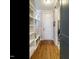 Hallway with wood flooring, a built-in storage bench, and a view into the adjacent room at 2609 Packhouse Rd, Zebulon, NC 27597