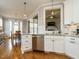 Spacious kitchen with stainless steel dishwasher, white cabinets, and granite countertops with hardwood flooring at 2609 Packhouse Rd, Zebulon, NC 27597