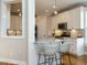 Modern kitchen with white cabinets, stainless steel appliances, granite countertops, and bar seating at 2609 Packhouse Rd, Zebulon, NC 27597