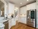 Kitchen featuring white cabinets, stainless steel appliances, granite countertops, and hardwood floors at 2609 Packhouse Rd, Zebulon, NC 27597