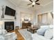 Spacious living room with a fireplace, hardwood floors, and access to other rooms at 2609 Packhouse Rd, Zebulon, NC 27597