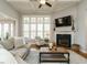 Inviting living room with a fireplace, coffered ceiling, and large windows with light-filtering blinds at 2609 Packhouse Rd, Zebulon, NC 27597