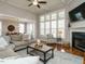 Bright living room with fireplace, coffered ceiling, large windows and hardwood floors at 2609 Packhouse Rd, Zebulon, NC 27597