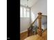 A staircase with wood steps, decorative metal railings, and natural light at 2609 Packhouse Rd, Zebulon, NC 27597