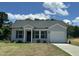 Charming single-Gathering home featuring gray siding, a black roof, a well-manicured lawn, and an attached garage at 272 Johnson Ridge Way, Four Oaks, NC 27524