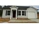 Charming single-story home featuring light siding, dark shutters, a garage, and a well-manicured lawn at 272 Johnson Ridge Way, Four Oaks, NC 27524