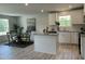 Modern kitchen with white cabinets, granite countertops, stainless steel appliances, and an adjacent dining area at 272 Johnson Ridge Way, Four Oaks, NC 27524