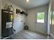 Bright laundry room features a water heater, washing machine hookup, and access door at 272 Johnson Ridge Way, Four Oaks, NC 27524