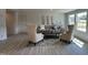 Bright living room featuring modern furniture, a neutral color palette, and plenty of natural light at 272 Johnson Ridge Way, Four Oaks, NC 27524
