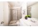 A neutral-colored bathroom featuring a glass-enclosed shower and a white vanity with a mirror at 272 Johnson Ridge Way, Four Oaks, NC 27524