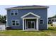 Backyard featuring a covered patio with sliding glass door and blue siding at 28 Longdale Dr, Graham, NC 27253