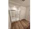 Bathroom featuring a glass-enclosed shower with white subway tiles and modern wood-look flooring at 28 Longdale Dr, Graham, NC 27253